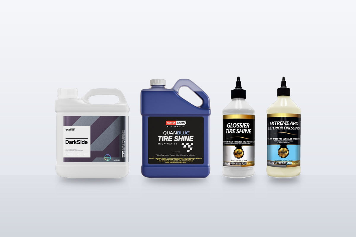 CarPro DarkSide gallon next to Quan Blue Tire Shine gallon, Symplex Glossier Tire Shine and Symplex Extreme APD