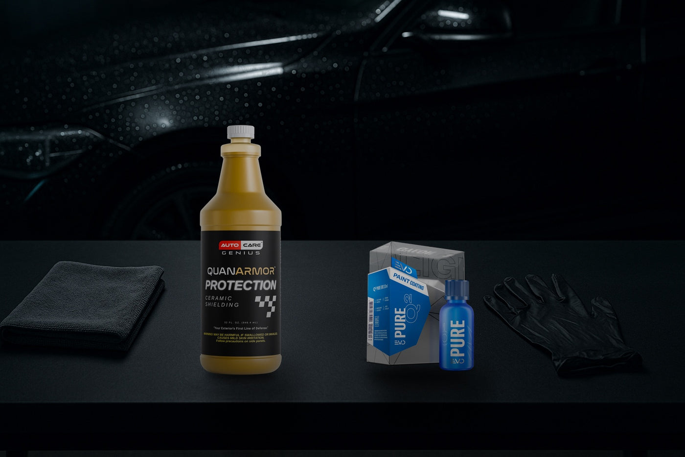 Quan Armor ceramic spray beside Gyeon Q² Pure EVO coating, with a beading black car panel behind