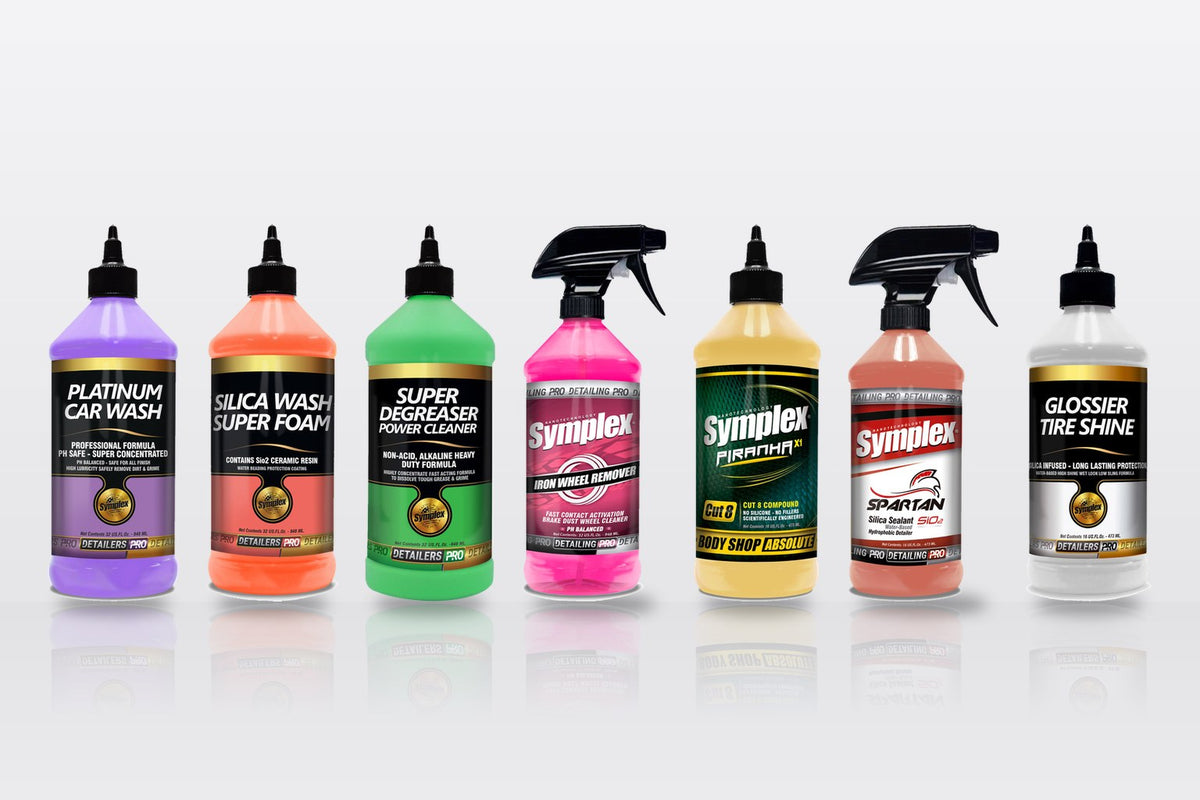 Symplex Platinum Car Wash, Silica Wash, Super Degreaser, Iron Wheel Remover, Piranha X1, Spartan SiO2 and Glossier Tire Shine bottles in a row
